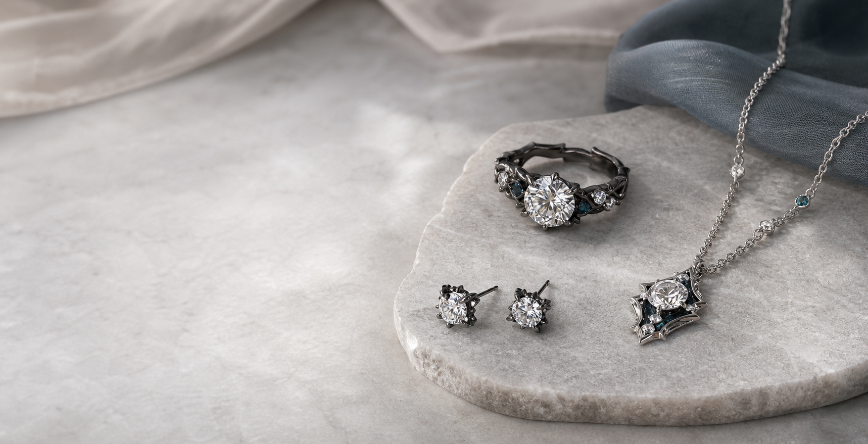 Custom laboratory-grown diamond ring, pendant, and earrings arranged on stone.